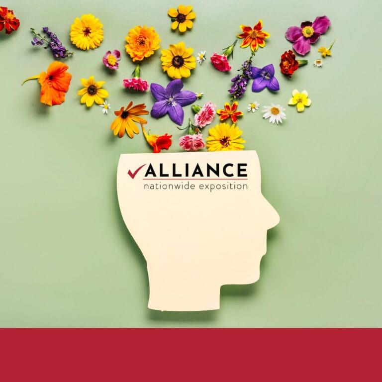 Photo of a head planter with flowers coming out of the top and the Alliance NAtionwide Exposition logo